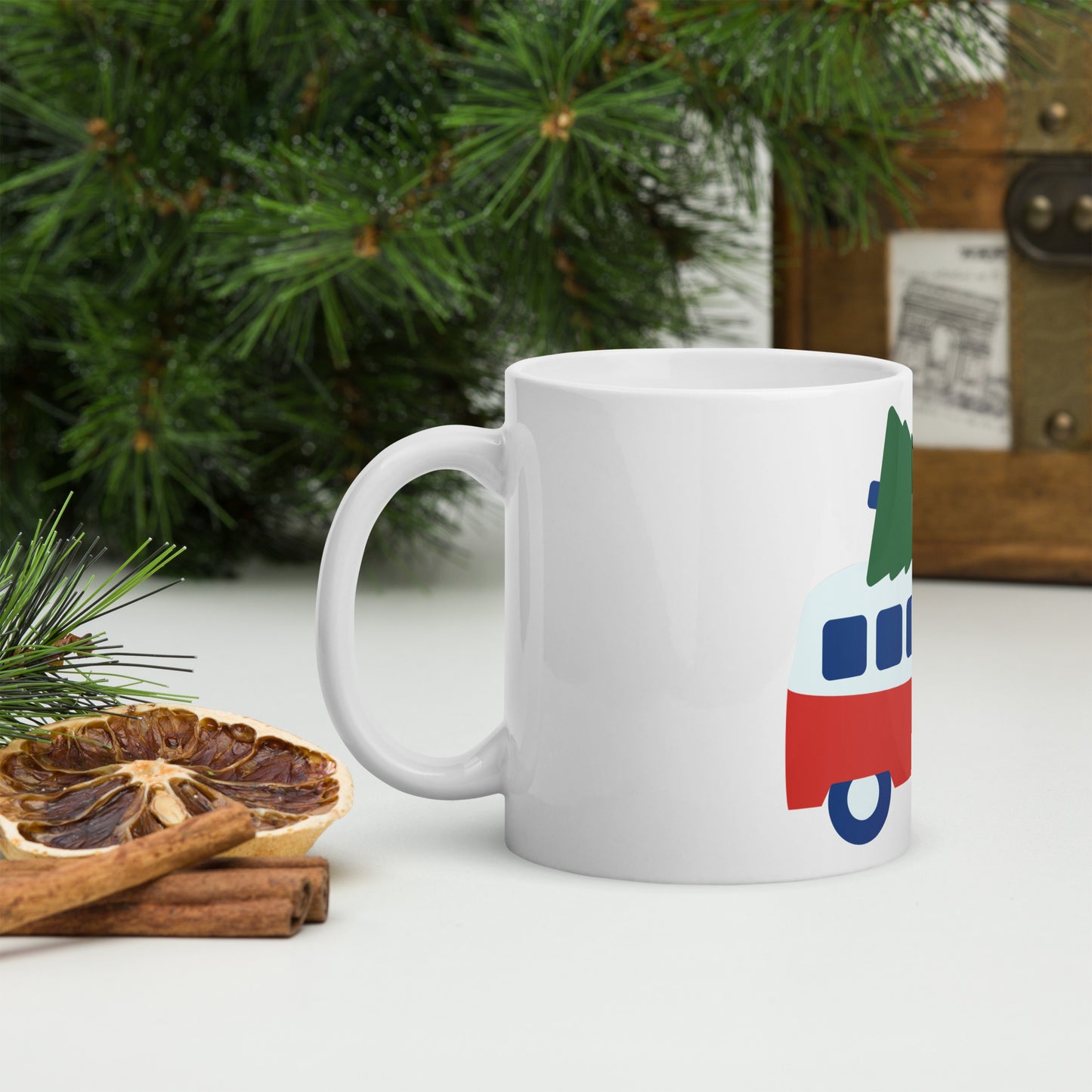 White glossy mug with retro camper van carrying a Christmas Tree